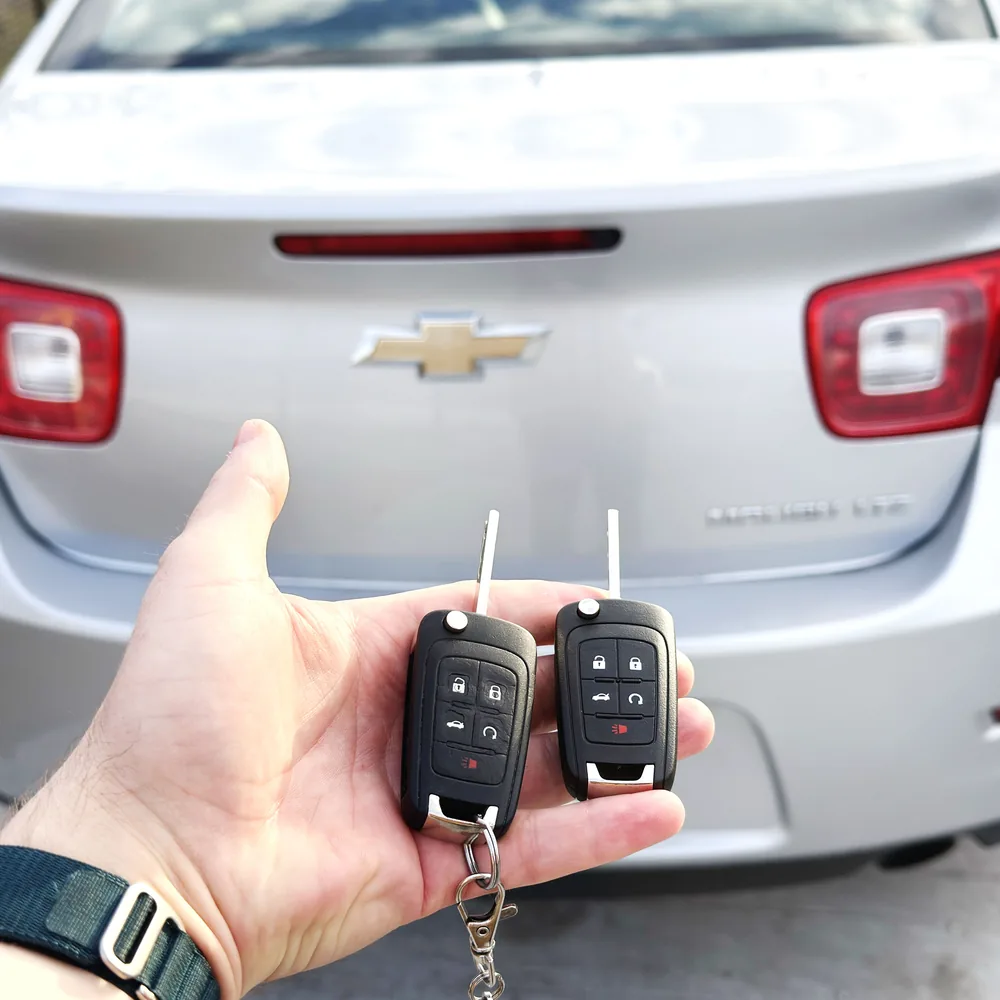 Two Chevrolet Malibu flip keys cut and programmed on-site in Winnipeg, Chevrolet bowtie behind