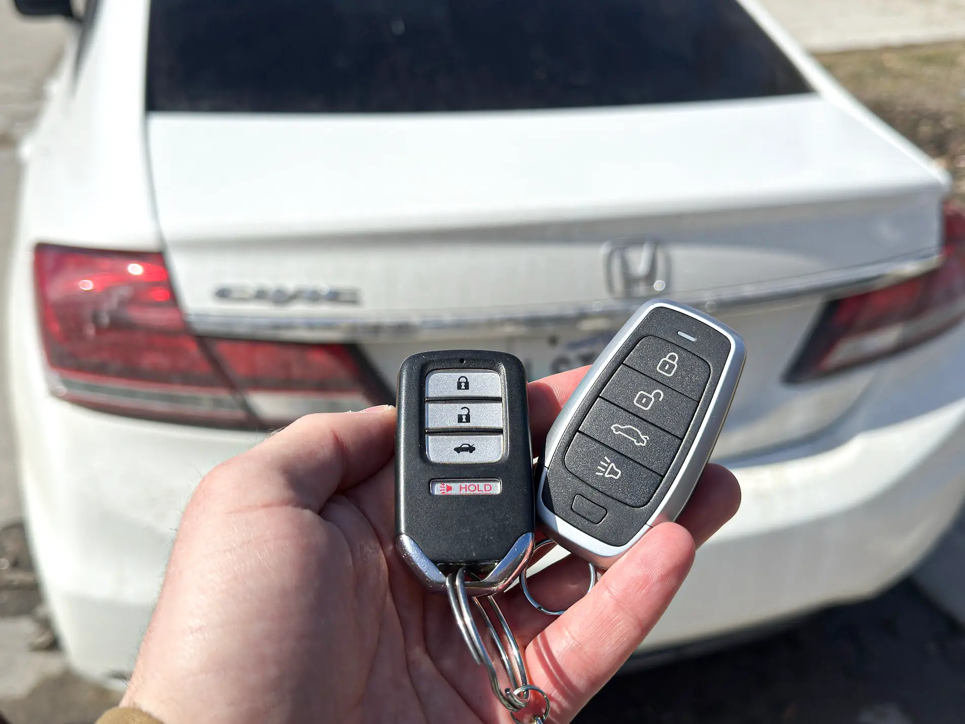 Honda Smart Key Touring fob next to traditional Civic LX transponder for trim-split visual