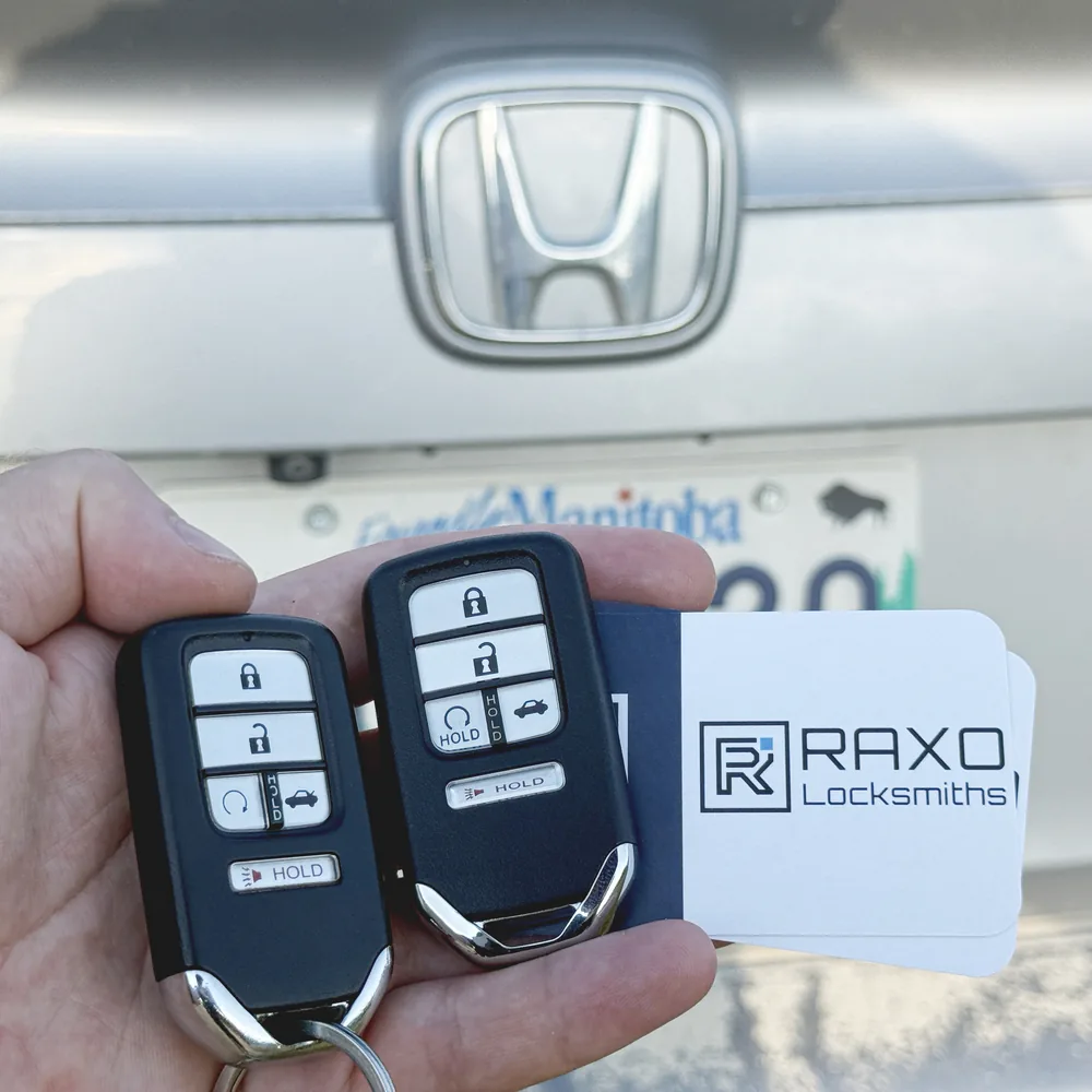 Two new 5-button Honda Civic smart keys cut and programmed at the car in Winnipeg, RAXO card at the tailgate