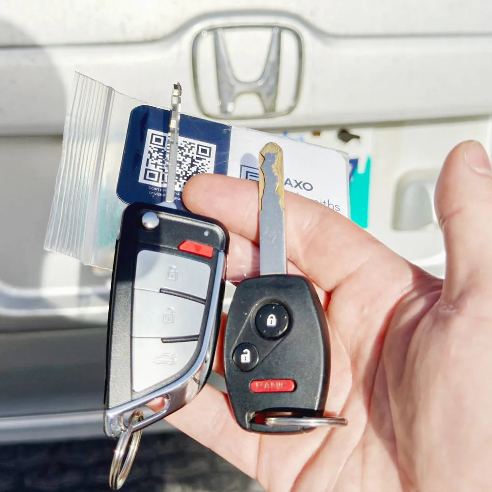 A durable flip-key upgrade beside the worn original key for a Honda Pilot in Winnipeg